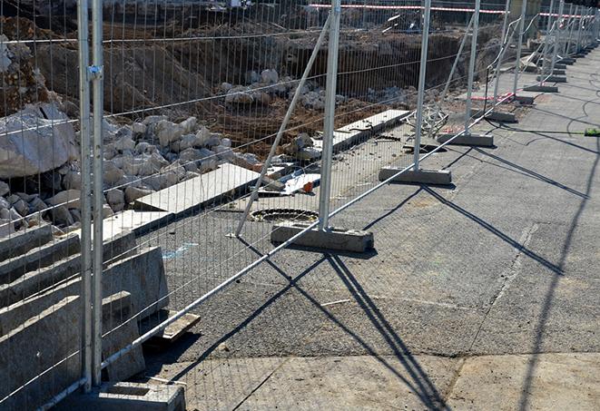 temporary fence panels lining a road to guide traffic flow